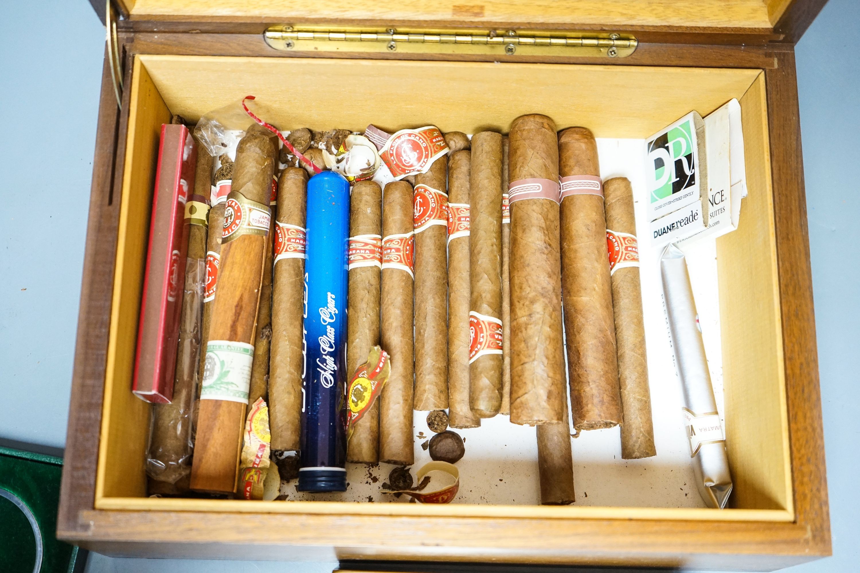 A cased Davidoff cigar cutter, walnut humidor, plated cigarette box, various cigars etc.